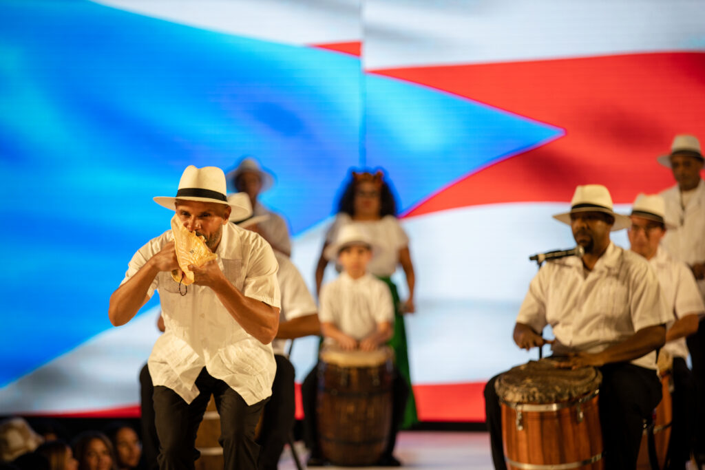 Performance by a group of drummers where a conch shell is being blown into. - New York Fashion Week