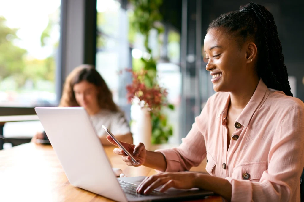 Two women working on laptops - Madison Ave Magazine